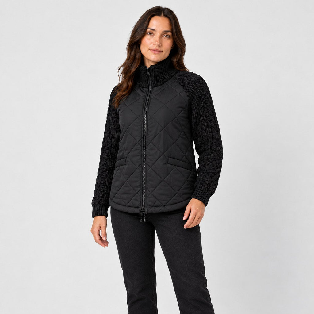 Women's quilted jacket with cable knit sleeves in Black | Luxulyan – side view