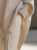 Women's oversized poncho jumper with asymmetric hem