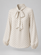 Women's polka dot blouse with a pussy bow tie neck