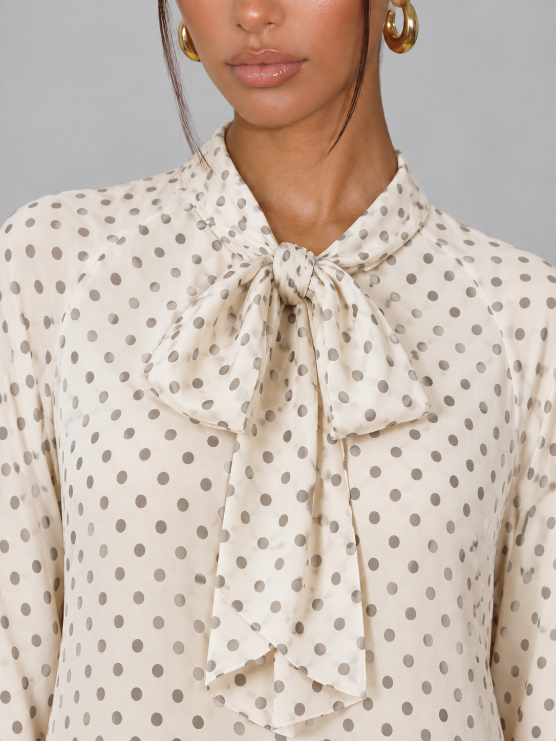 Women's polka dot blouse with a pussy bow tie neck
