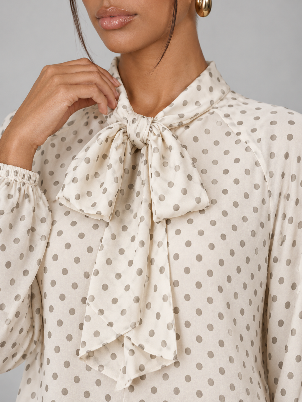 Women's polka dot blouse with a pussy bow tie neck