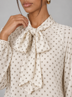 Women's polka dot blouse with a pussy bow tie neck