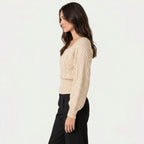 Women's cropped cable knit jumper with puff sleeves in Beige | Ickleton – side view