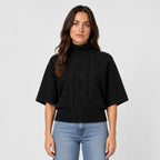 Women's cable knit turtleneck with cape sleeves in Black | Grinton – front view